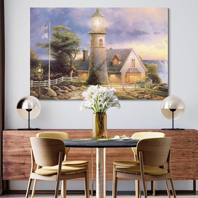STUDIO HAVEN Thomas Kinkade Canvas Wall Art, Lighthouse Cottage Beacon with American Flag White Fence Ocean Sunset Oil Painting Poster Coastal Wall Decor, Framed Prints for Home Decor, 16x12Inch